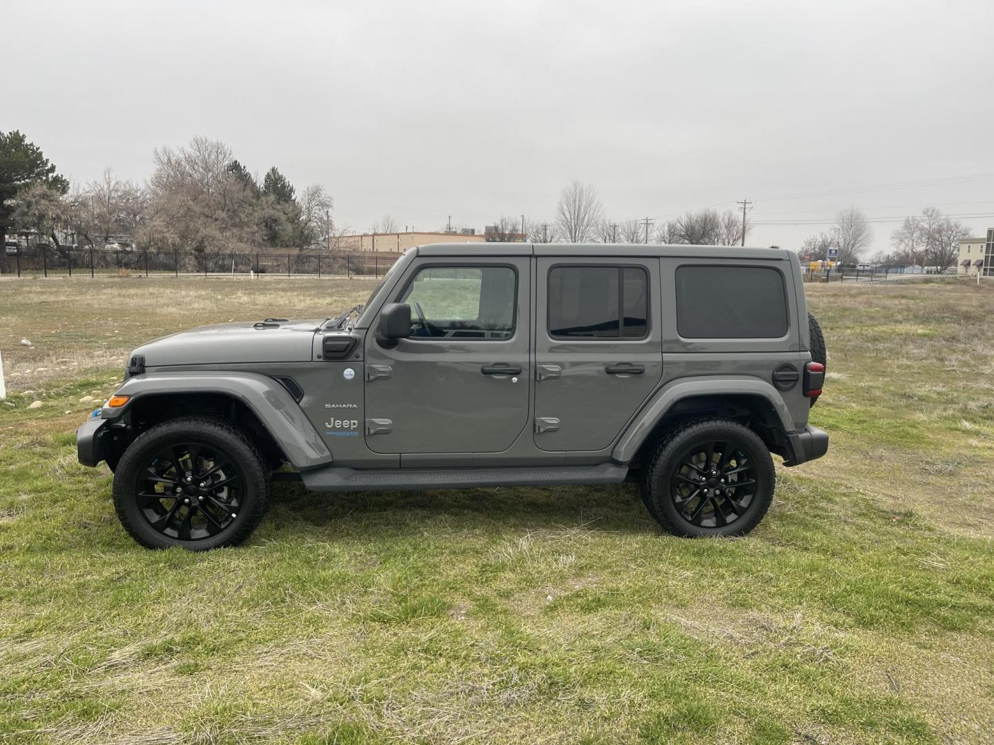 2022 Grey /Black Jeep Wrangler Unlimited Sahara 4XE (1C4JJXP62NW) with an 2.0L L4 DOHC 16V HYBRID engine, AT transmission, located at 813 E Fairview Ave, Meridian , ID, 83642, (208) 336-8230, 43.618851, -116.384010 - What a nice Jeep, Very clean, and highly optioned. If you want a nice Wrangler come take a look. This will give you great service for a long long time and when you plug this in and use the hybrid this vehicle gets you around with no gas, its the best of both worlds. This Wrangler has leather, exce - Photo#0